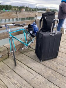 A bicycle and a suitcase on a ferry dock.